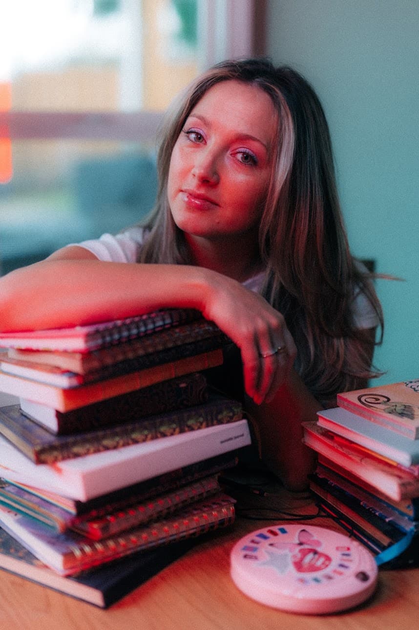 Megan Monty with a stack of books