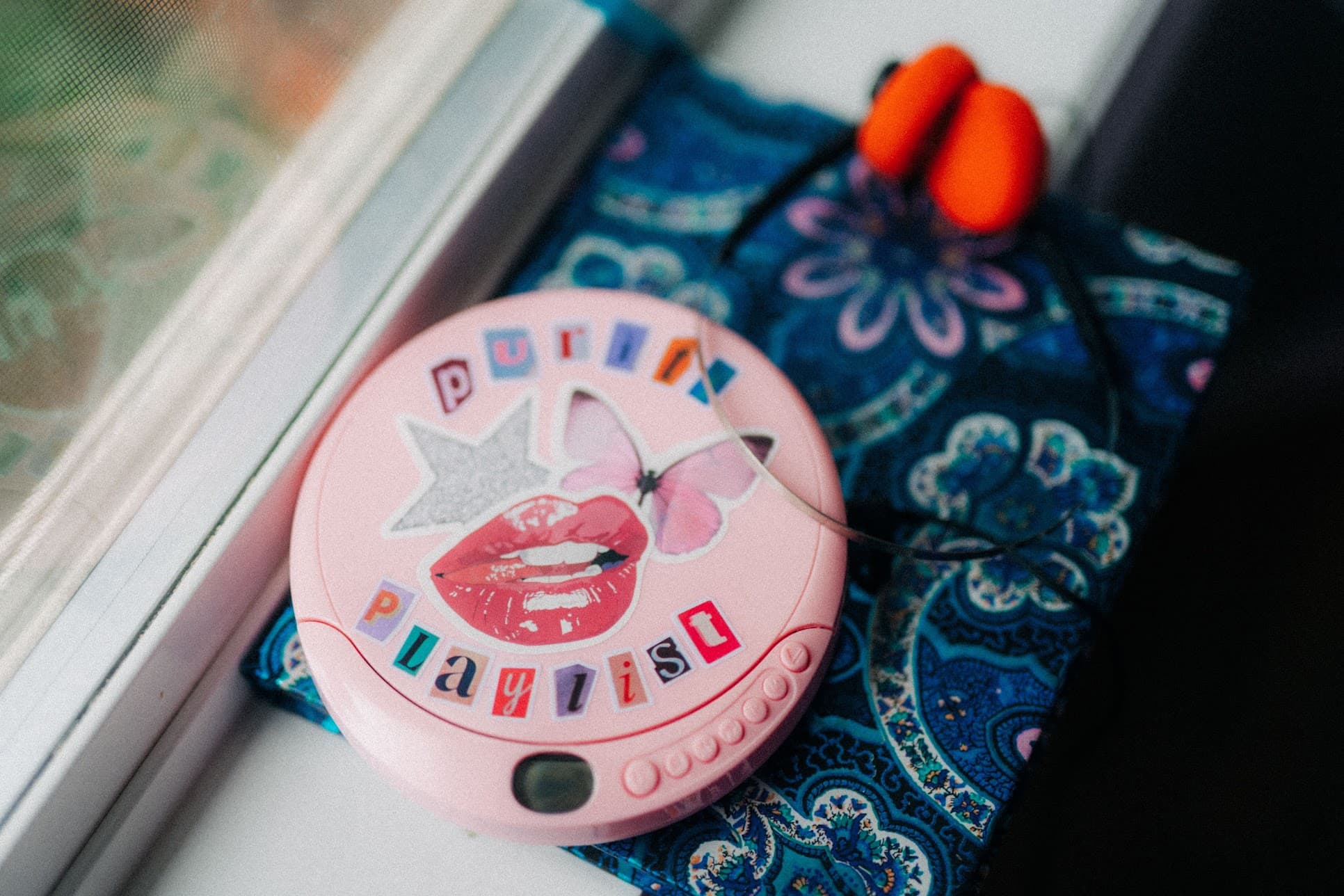 A handmade Purity Playlist CD player by a sunny window